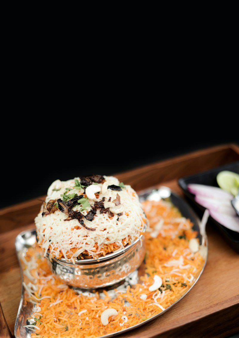 Mutton biryani served on a wooden tray